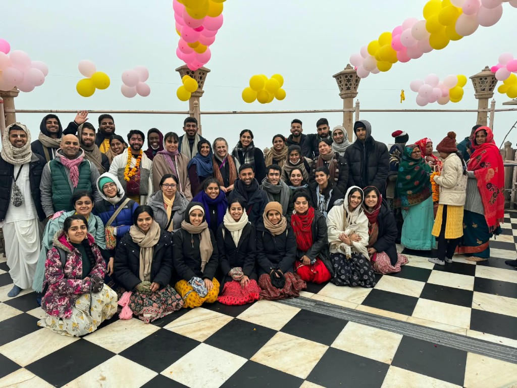 Large outdoor group photo on a checkered terrace